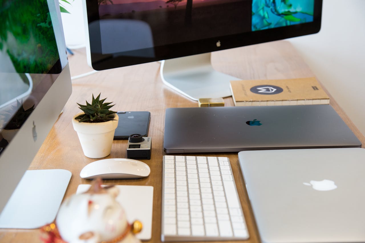 Mastering the First Impression: Your intriguing post title goes here A clean and organized office workspace featuring Apple devices including iMac and MacBook with a plant for decor.